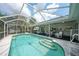 Inviting screened pool features a seating area and steps, perfect for enjoying outdoor Florida living at 4055 Alwick Ln, North Port, FL 34287