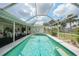 Relaxing screened pool with clear blue water, tile trim, and covered lanai seating area, perfect for Florida outdoor living at 4055 Alwick Ln, North Port, FL 34287