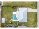 Birds eye view of property featuring a modern rectangular pool, metal roof, long driveway and spacious yard at 416 Allen St, Punta Gorda, FL 33950