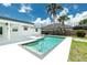 Beautiful backyard featuring a sparkling pool with a spa and mature landscaping at 416 Allen St, Punta Gorda, FL 33950