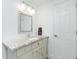 Bathroom featuring granite countertop, large mirror and updated cabinets at 416 Allen St, Punta Gorda, FL 33950