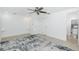 A bright bedroom featuring an area rug, ceiling fan, and access to a bathroom at 416 Allen St, Punta Gorda, FL 33950
