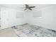 A bright bedroom featuring an area rug, ceiling fan, and natural lighting from two windows at 416 Allen St, Punta Gorda, FL 33950
