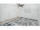 A bright bedroom featuring an area rug, ceiling fan, and two closets for optimal storage at 416 Allen St, Punta Gorda, FL 33950