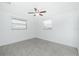 Bright bedroom featuring a ceiling fan, neutral walls, and tiled flooring at 416 Allen St, Punta Gorda, FL 33950