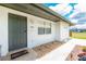 Front door detail of home featuring a gray door and fresh rock landscaping at 416 Allen St, Punta Gorda, FL 33950