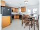 Spacious kitchen with wooden cabinets, tile flooring, black appliances, and dining area with table at 416 Allen St, Punta Gorda, FL 33950