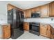 A kitchen with updated appliances and wooden cabinets at 416 Allen St, Punta Gorda, FL 33950