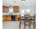 Bright eat-in kitchen area with modern appliances, light wood cabinets, granite countertops and patio access at 416 Allen St, Punta Gorda, FL 33950