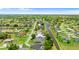 Real estate aerial view showcases a tranquil neighborhood with canals, lush landscaping, and private pools at 425 Corrientes Cir, Punta Gorda, FL 33983