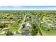 Real estate aerial view showcases a tranquil neighborhood with canals, lush landscaping, and private pools at 425 Corrientes Cir, Punta Gorda, FL 33983