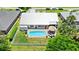 Drone image revealing a backyard oasis, featuring a pool, patio, and privacy fence, perfect for outdoor living at 425 Corrientes Cir, Punta Gorda, FL 33983