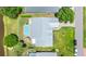 Aerial view showcasing the property's layout, including the pool, patio, and well-manicured lawn at 425 Corrientes Cir, Punta Gorda, FL 33983