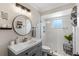 Modern bathroom featuring white subway tile, patterned floor tiles, and glass enclosed shower at 425 Corrientes Cir, Punta Gorda, FL 33983