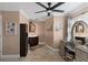Elegant bathroom featuring a vanity with dark wood cabinets, neutral walls, and a stylish ceiling fan at 425 Corrientes Cir, Punta Gorda, FL 33983