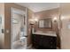 Cozy bathroom showcasing a dark wood vanity with marble countertop and an adjacent powder room at 425 Corrientes Cir, Punta Gorda, FL 33983