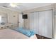 Bright bedroom featuring neutral walls, hardwood floors, a ceiling fan, and ample closet space at 425 Corrientes Cir, Punta Gorda, FL 33983