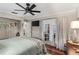 Spacious bedroom with a ceiling fan, hardwood floors, and French doors leading to outdoor space at 425 Corrientes Cir, Punta Gorda, FL 33983