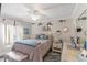 Comfortable bedroom with a ceiling fan, light-colored walls, and nautical decorations at 425 Corrientes Cir, Punta Gorda, FL 33983
