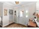 Bright foyer showcasing tile floors, decorative mirrors, coat hangers, and a stylish entryway at 425 Corrientes Cir, Punta Gorda, FL 33983