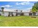 Attractive home boasting a neat lawn, palm trees, dormer windows and a two-car gray garage door at 425 Corrientes Cir, Punta Gorda, FL 33983