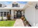 Inviting front porch with seating, decorative lanterns, a stone pathway, and tasteful landscaping at 425 Corrientes Cir, Punta Gorda, FL 33983