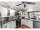 Charming kitchen features white cabinetry, stainless steel appliances, and stylish decor at 425 Corrientes Cir, Punta Gorda, FL 33983