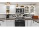 Modern kitchen featuring white cabinets, subway tile backsplash, and stainless steel appliances at 425 Corrientes Cir, Punta Gorda, FL 33983