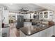 Bright eat-in kitchen boasts white cabinets, stainless steel appliances, and a breakfast bar at 425 Corrientes Cir, Punta Gorda, FL 33983