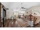 Inviting living room boasts hardwood floors, a leather sectional, a ceiling fan, and a large display cabinet at 425 Corrientes Cir, Punta Gorda, FL 33983