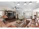 Bright living room features a ceiling fan, hardwood floors, a leather sectional, and an entertainment center at 425 Corrientes Cir, Punta Gorda, FL 33983