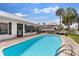 Refreshing swimming pool with ample deck space, palm trees, and a charming outdoor dining area at 425 Corrientes Cir, Punta Gorda, FL 33983