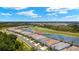 Community aerial view featuring residential homes situated near a lake and a meticulously kept golf course at 43406 Boardwalk Loop, Punta Gorda, FL 33982