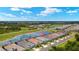 Aerial view of community homes along a lake and golf course with beautiful green surroundings at 43406 Boardwalk Loop, Punta Gorda, FL 33982