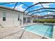 Enjoy the screened pool, outdoor kitchen, and lake view on this home's patio at 43406 Boardwalk Loop, Punta Gorda, FL 33982
