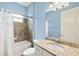 Bright bathroom features granite counters, a bathtub with tiled shower, and neutral paint at 43406 Boardwalk Loop, Punta Gorda, FL 33982