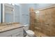 Bathroom featuring a granite vanity and tiled shower with a sliding glass door at 43406 Boardwalk Loop, Punta Gorda, FL 33982
