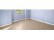 Bedroom with light blue walls, wood-look tile floor and a window at 43406 Boardwalk Loop, Punta Gorda, FL 33982