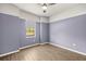 Bedroom featuring wood-look tile floors, neutral wall color and ample natural light at 43406 Boardwalk Loop, Punta Gorda, FL 33982