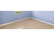 Bedroom with light blue walls, wood-look tile floor and a window for natural light at 43406 Boardwalk Loop, Punta Gorda, FL 33982