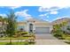 Charming single-story home features a paver driveway, lush landscaping, and a welcoming front entrance at 43406 Boardwalk Loop, Punta Gorda, FL 33982