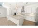 Modern kitchen featuring white cabinets, quartz countertops, stainless steel appliances, and a large island at 43406 Boardwalk Loop, Punta Gorda, FL 33982