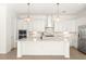 Spacious kitchen featuring a large island, stainless steel appliances, and modern pendant lighting at 43406 Boardwalk Loop, Punta Gorda, FL 33982