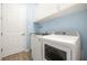 Laundry room with granite counters, white cabinets and blue walls at 43406 Boardwalk Loop, Punta Gorda, FL 33982