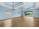 Spacious living area with sliding glass doors to the screened-in lanai and a view of the pool at 43406 Boardwalk Loop, Punta Gorda, FL 33982