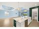 Bright open-concept living area featuring tile floors, kitchen island and access to outdoor patio at 43406 Boardwalk Loop, Punta Gorda, FL 33982