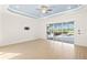 Bright living room with tile flooring, ceiling fan, and sliding glass doors to the pool area at 43406 Boardwalk Loop, Punta Gorda, FL 33982