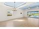 Open floor plan with tile flooring, decorative ceiling, and views of the pool and outdoor living space at 43406 Boardwalk Loop, Punta Gorda, FL 33982