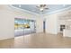Open-concept living space with tile flooring, kitchen access, and sliding glass doors to the pool at 43406 Boardwalk Loop, Punta Gorda, FL 33982