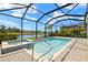 Enjoy the screened-in pool, hot tub, and picturesque lake view in this backyard retreat at 43406 Boardwalk Loop, Punta Gorda, FL 33982